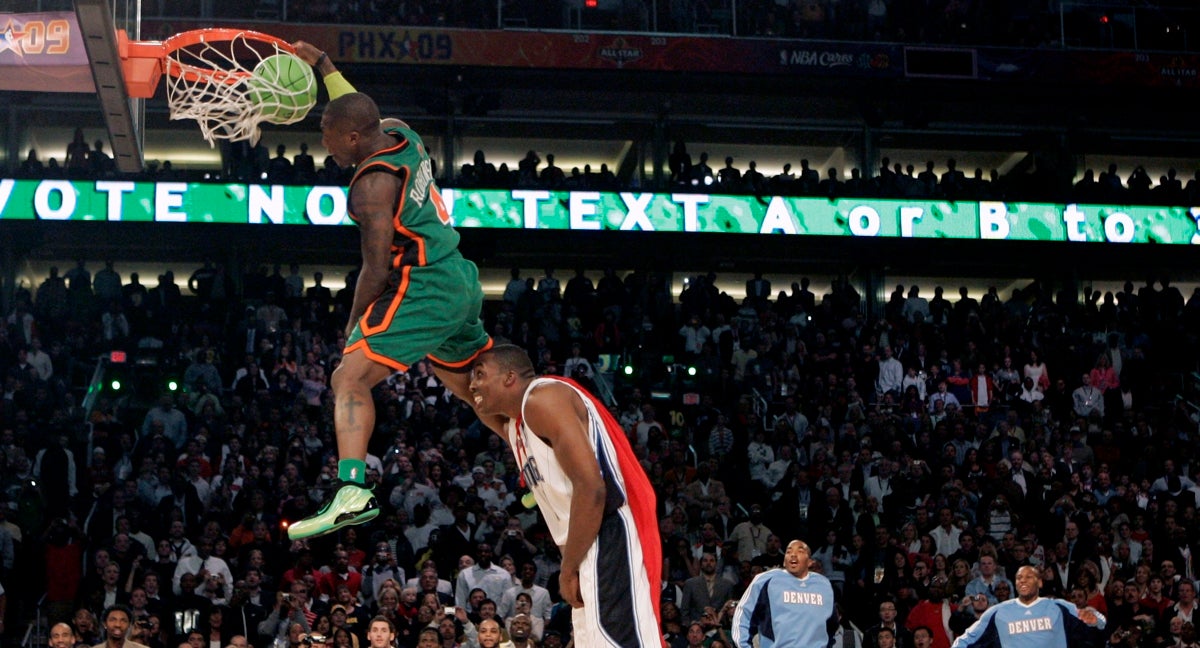 Nate Robinson machaca el aro por encima de Dwight Howard en el concurso de mates de 2009.