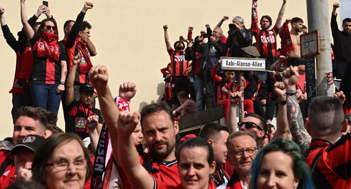 Aficionados posan con un cartel de la Avenida Xabi Alonso. /INA FASSBENDER / AFP