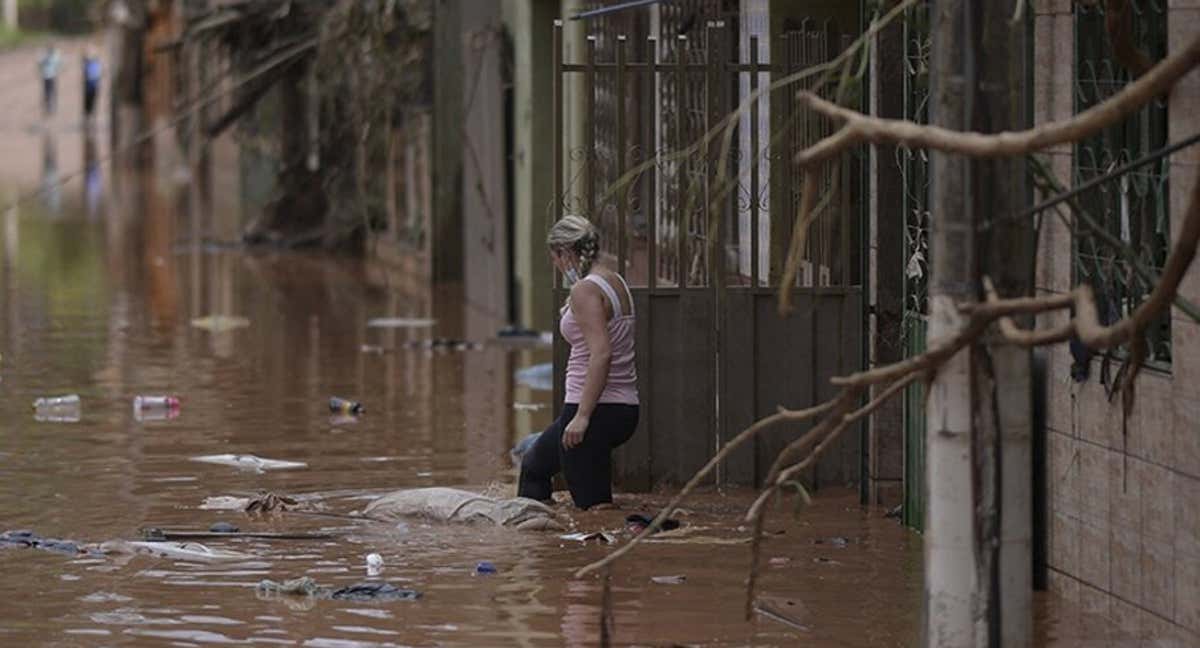 Una afectada por las inundaciones sale de su vivienda./RRSS